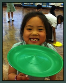 Plate Spinning in a Circus Skills workshop at a School in Guildford